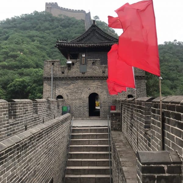 Shiguan Great Wall with red flags and restored watchtower